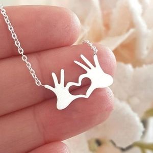 Silvertone Heart Hands necklace
